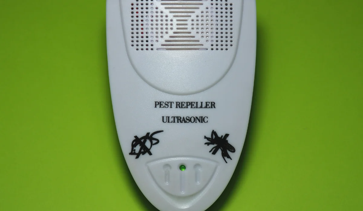 White ultrasonic pest repeller with 'PEST REPELLER ULTRASONIC' text and insect icons on a green background